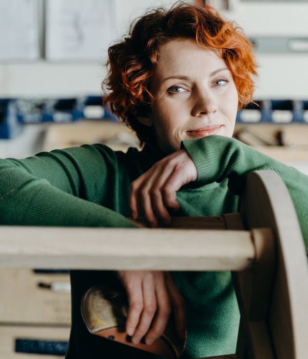 A person sitting cross-legged, looking relaxed and content.