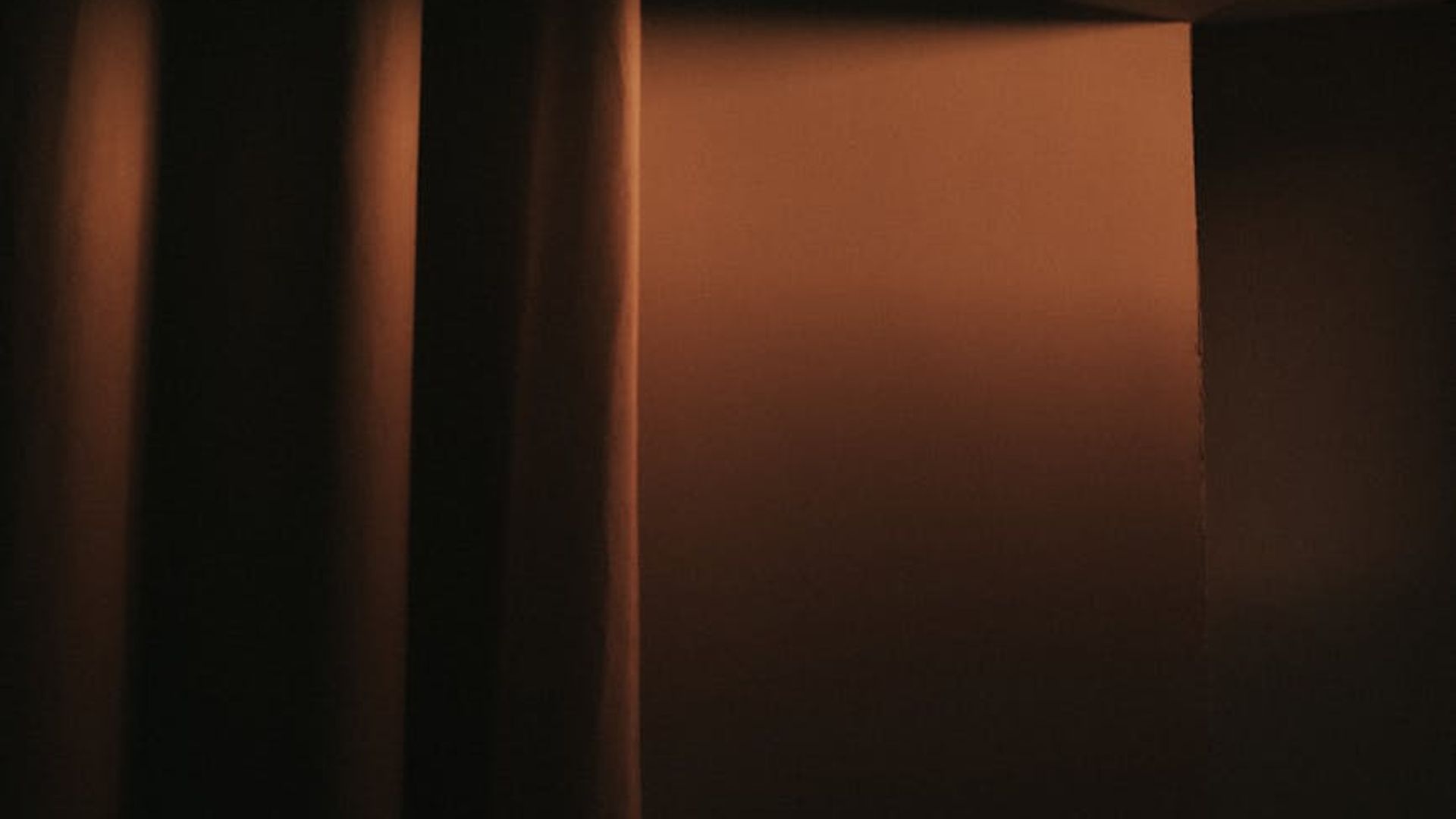 Peaceful and dark yoga room with subtle atmospheric light.